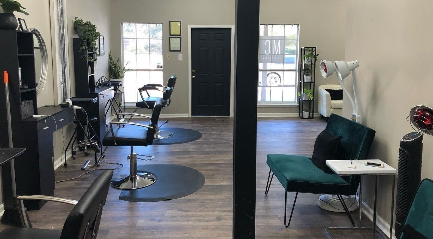 Modern interior of MC Hair Studio in Little Rock, Arkansas, US with styling chairs and elegant decor.