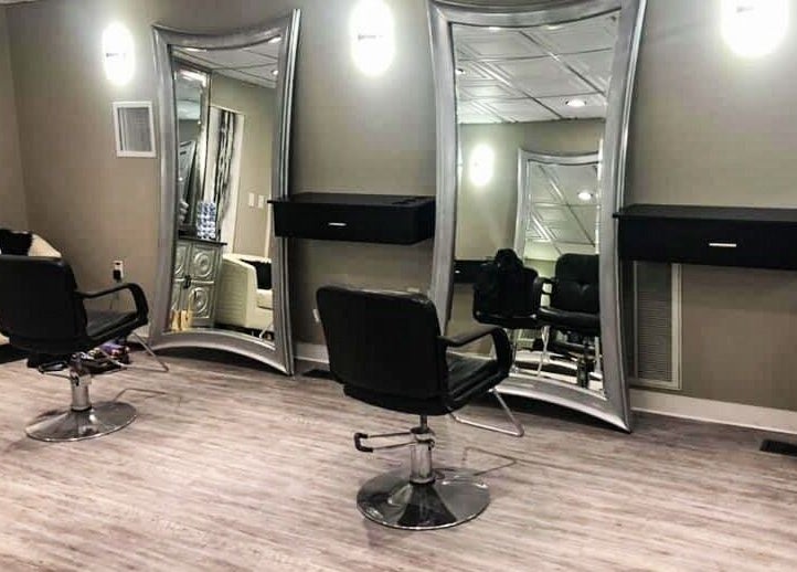 Modern chic salon interior at MC Hair Studio, Little Rock, Arkansas, US with stylish mirrors and seating.