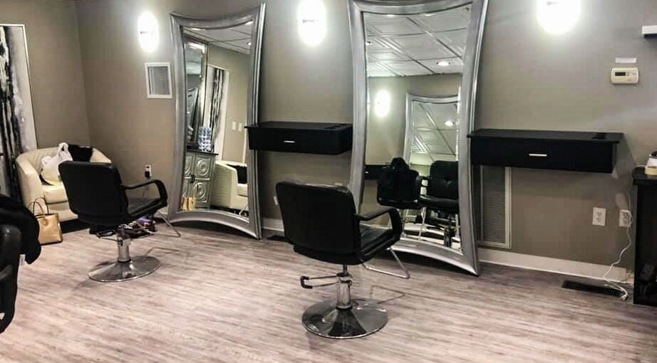 Modern chic salon interior at MC Hair Studio, Little Rock, Arkansas, US with stylish mirrors and seating.