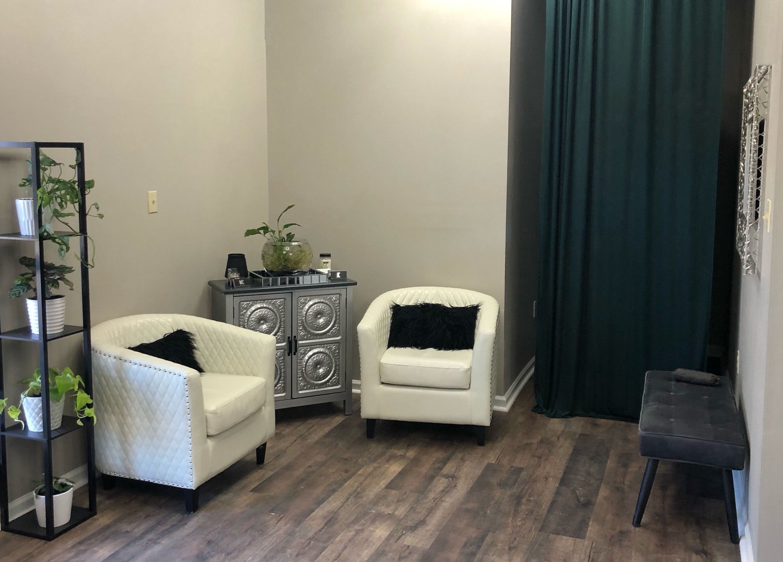Inviting seating area at MC Hair Studio, Little Rock, Arkansas, US with elegant chairs and greenery.