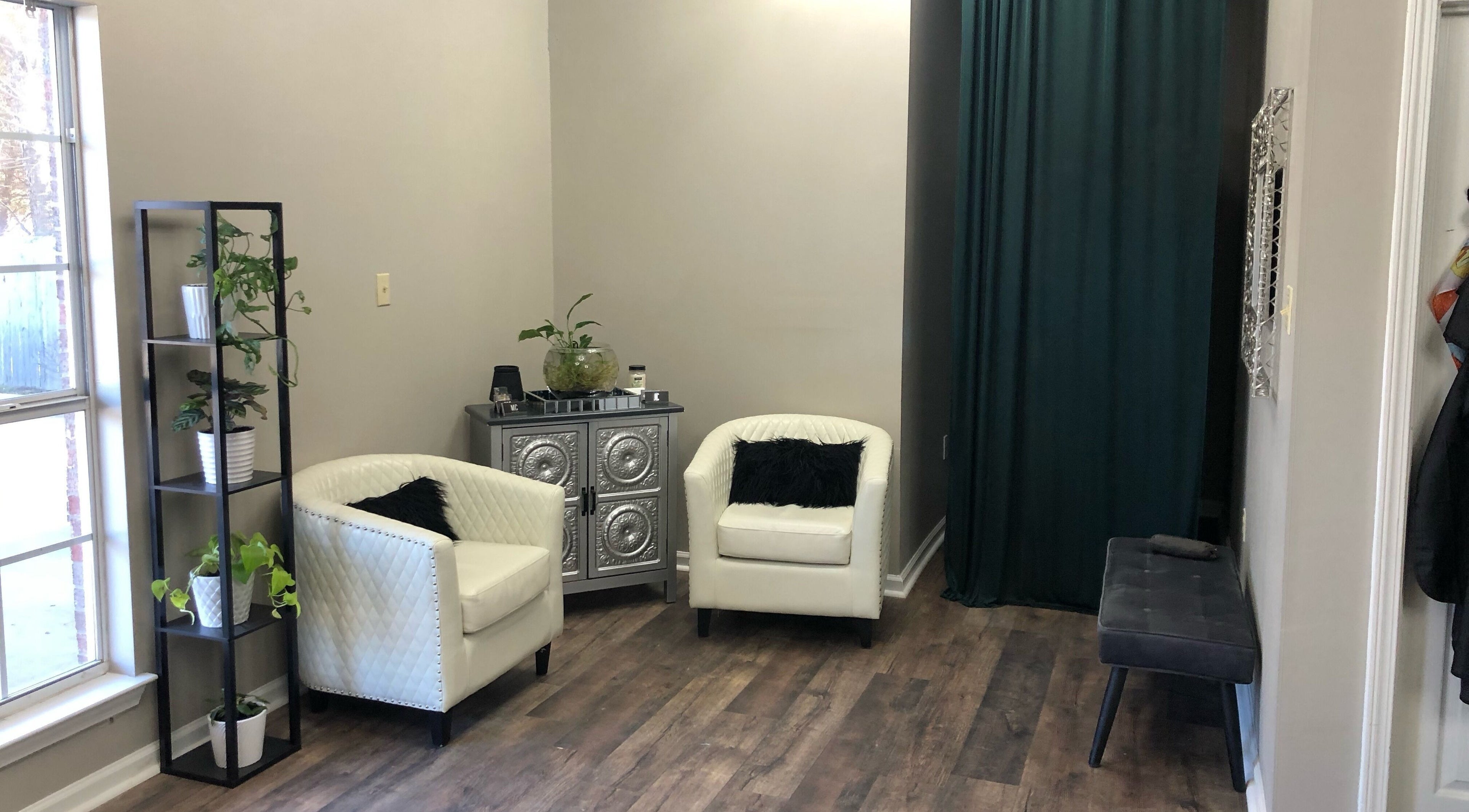 Inviting seating area at MC Hair Studio, Little Rock, Arkansas, US with elegant chairs and greenery.