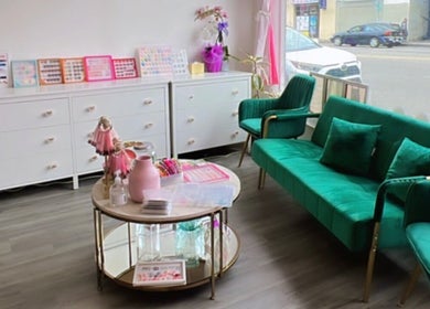 Elegant interior of Politur Nails Beauty Lounge in Los Angeles, California, US showcasing plush seating and nail color displays.