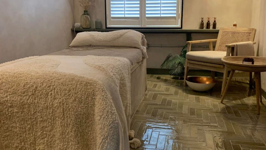 Cozy massage room at Elixir, Royal Leamington Spa, England, GB. Features plush bed and soothing decor.