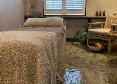Cozy massage room at Elixir, Royal Leamington Spa, England, GB. Features plush bed and soothing decor.