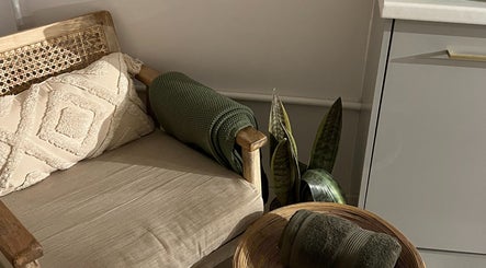 A cozy seating area with cushions and a plant at elixir, Royal Leamington Spa, England, GB.