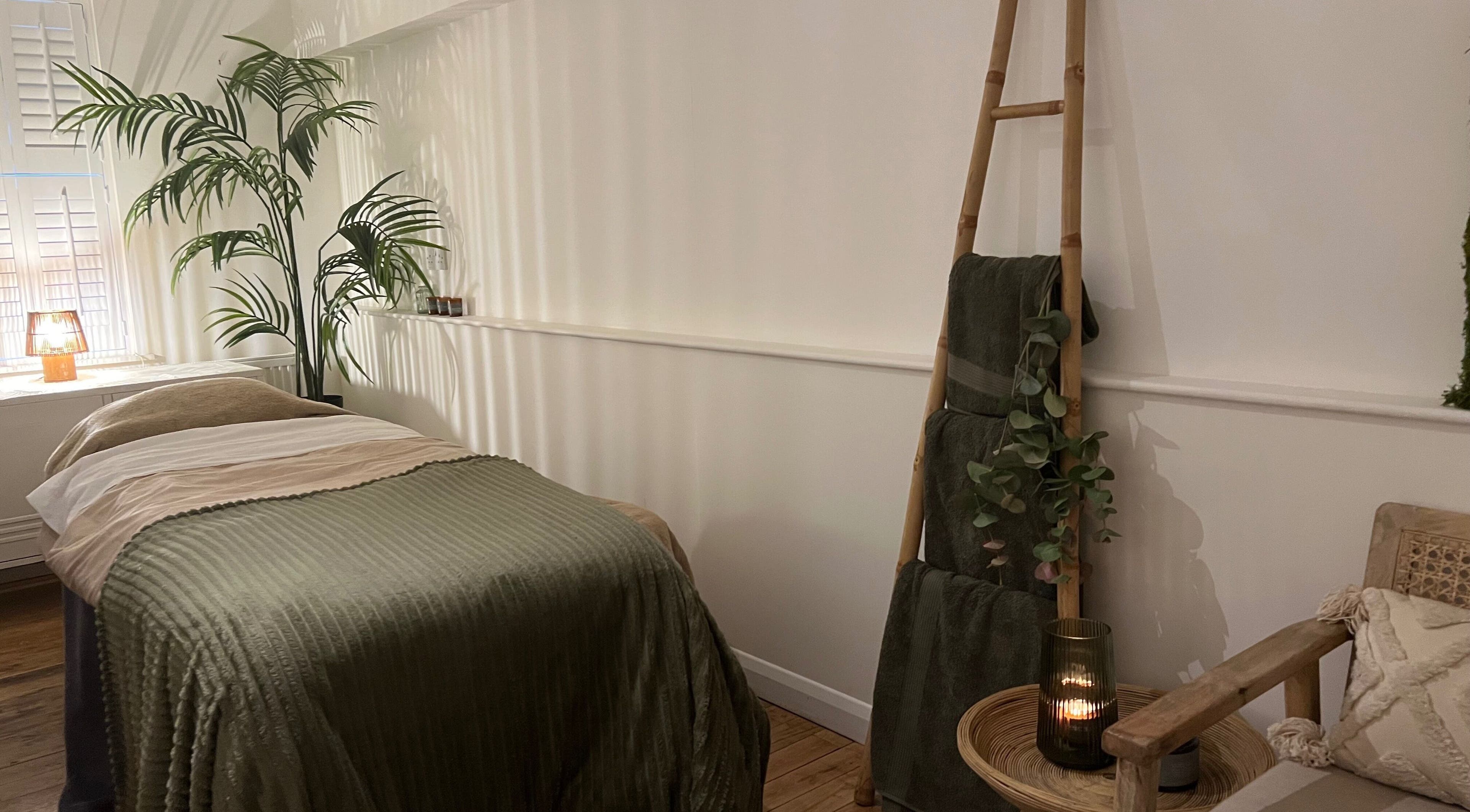 Peaceful treatment room at elixir/ in Royal Leamington Spa, England, with a cozy bed and ambient lighting.