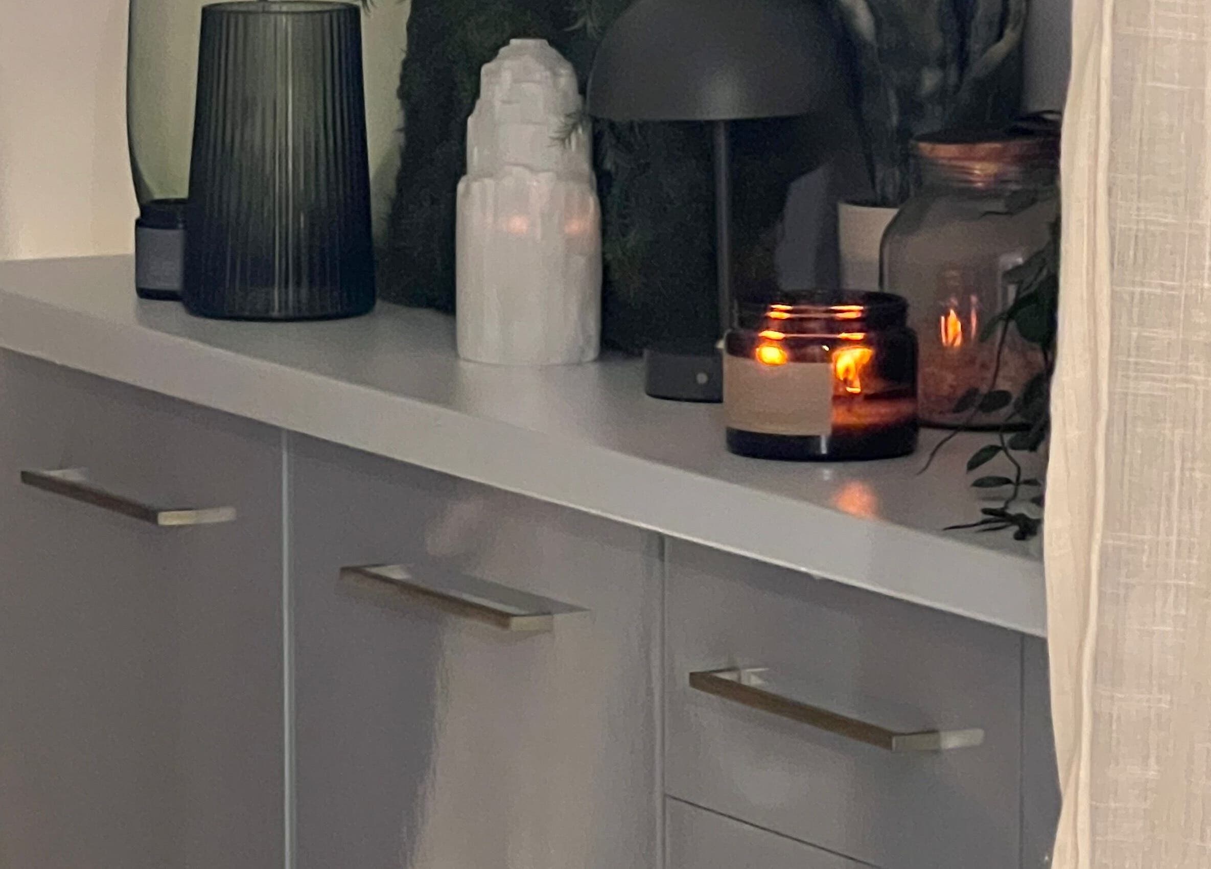 Elixir/ spa ambiance with candles on shelf in Royal Leamington Spa, England, GB, creating a serene atmosphere.
