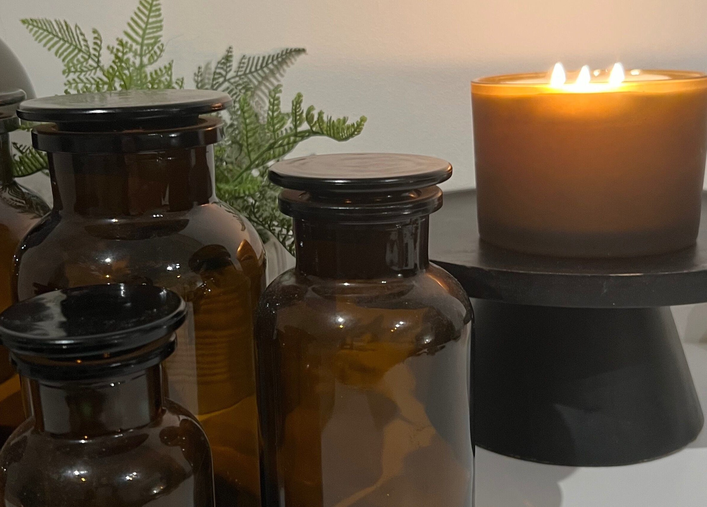 Cozy spa setup at elixir/ in Royal Leamington Spa, England, GB with candles and aromatherapy jars.