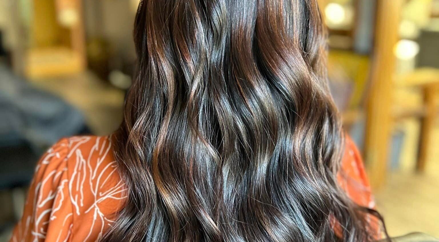 Shiny, wavy brunette hair styled at Lucy at C Reflections Salon & Day Spa, Morrill, Nebraska, US.