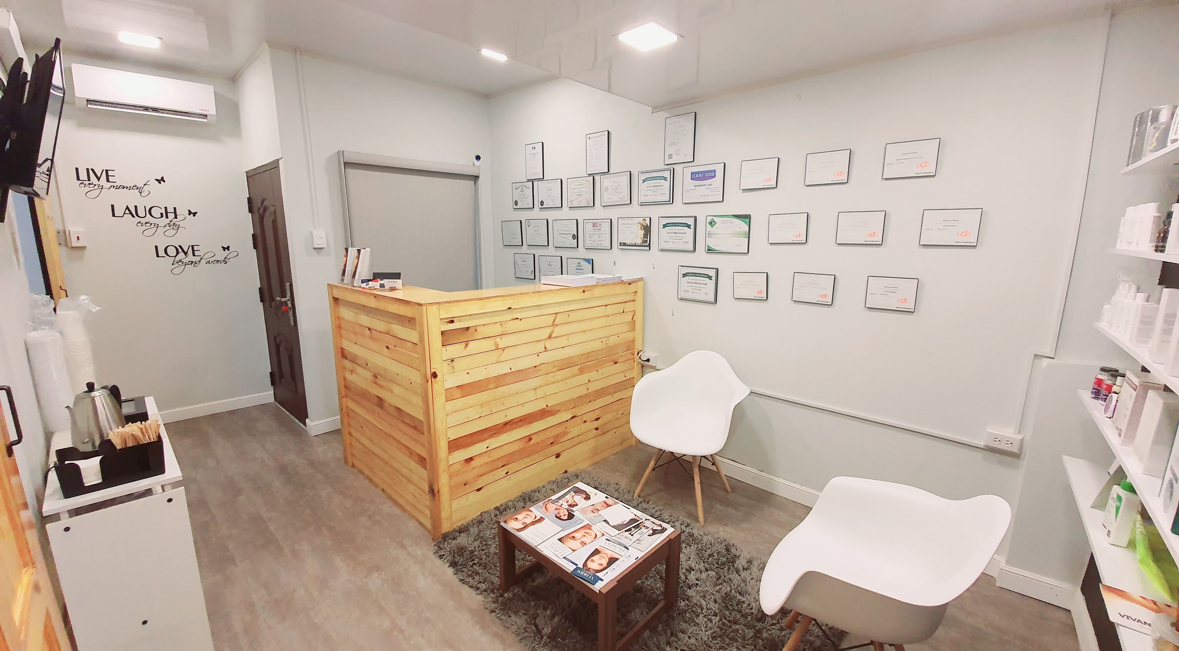 Reception area at The DermLab Freeport TT with cozy seating and certificate display.