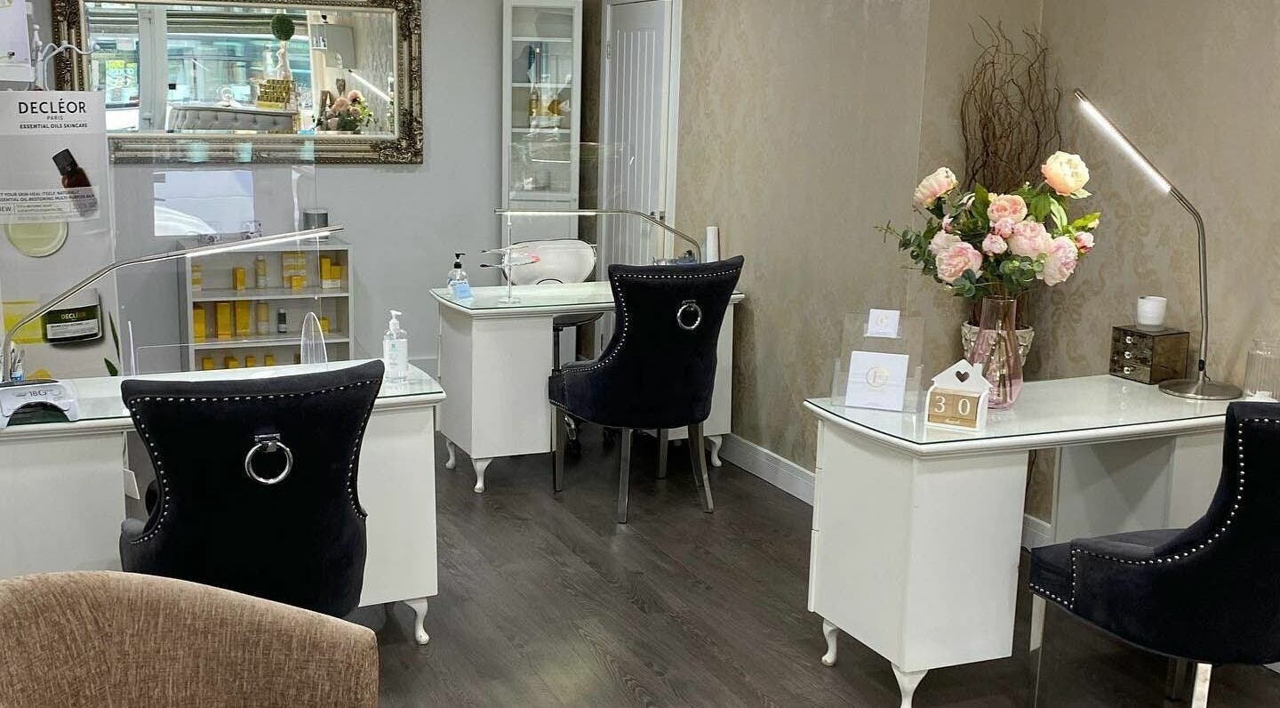 Interior of Flawless in Shaw, England, GB featuring nail stations and floral decor.