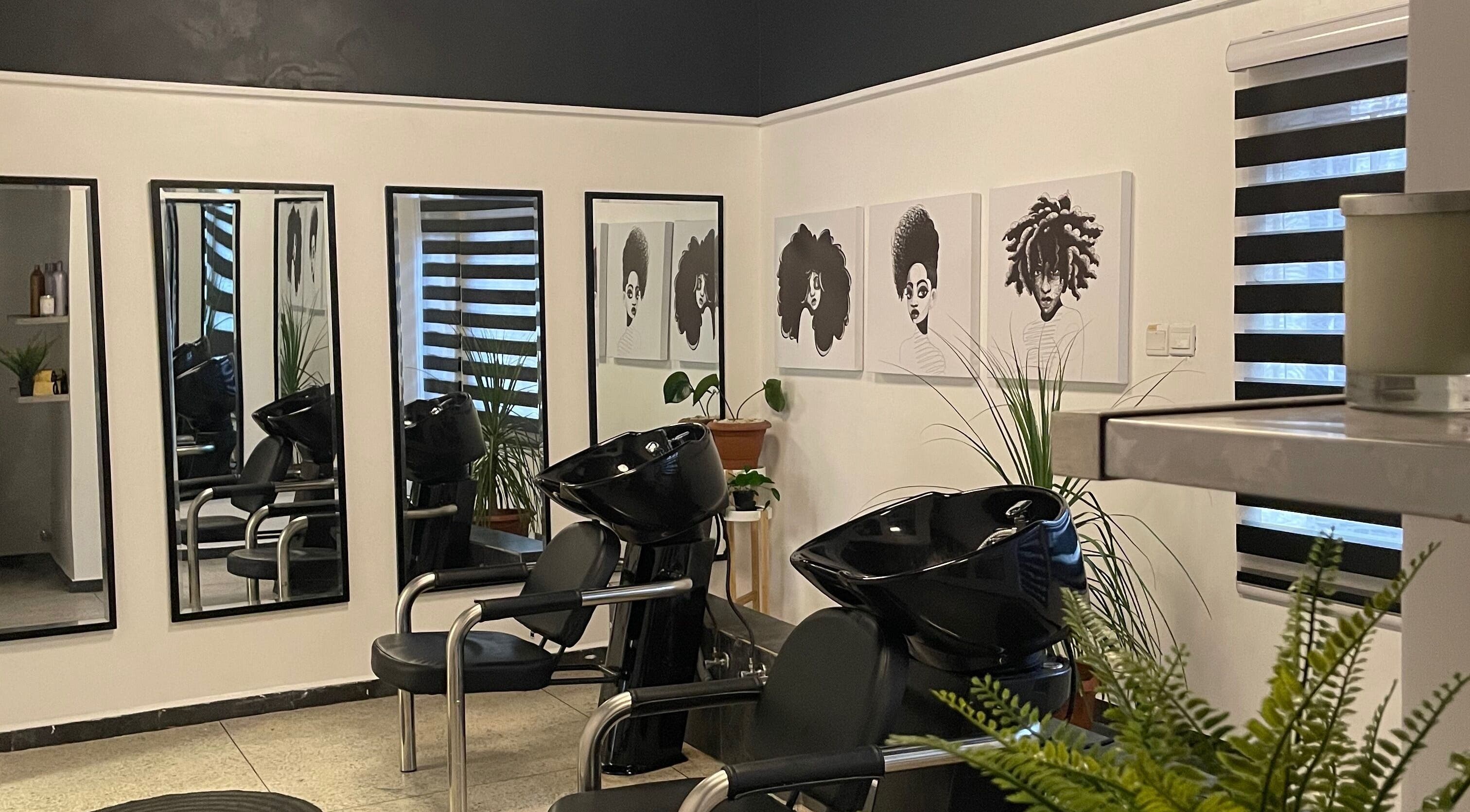 Modern salon interior at Tresses Lagos, featuring stylish decor and washing stations. Located in Lagos, Lagos, NG.