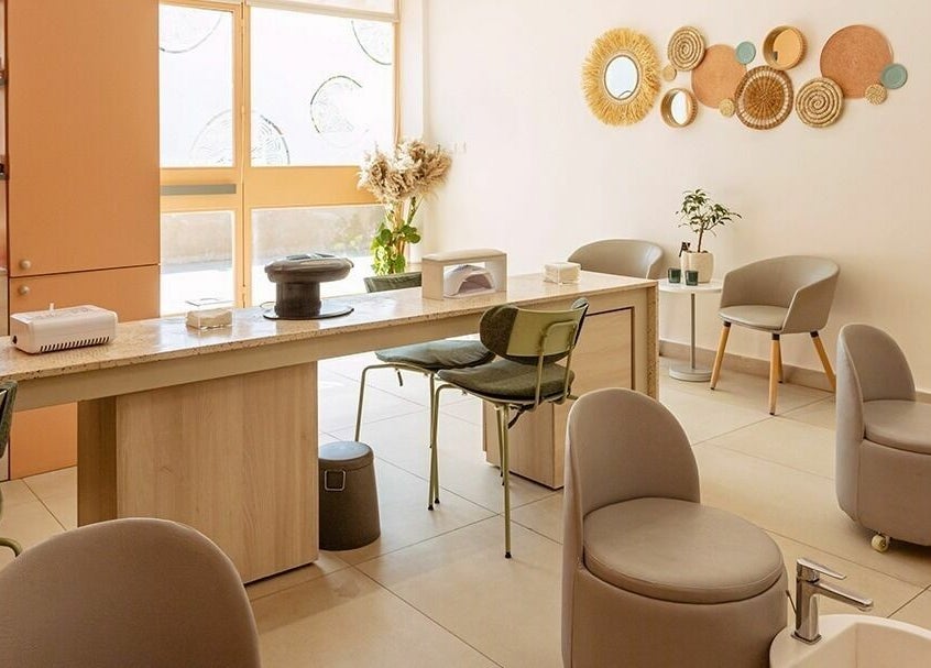 Elegant nail salon interior at Calamantina, Aqaba, Aqaba Governorate, JO, featuring modern decor and comfortable seating.