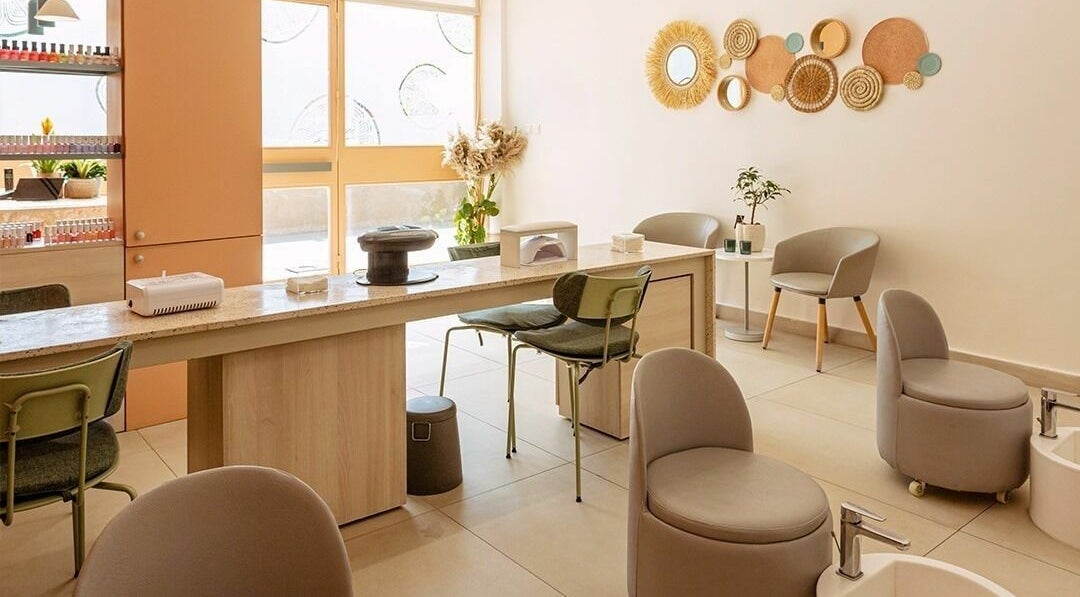 Elegant nail salon interior at Calamantina, Aqaba, Aqaba Governorate, JO, featuring modern decor and comfortable seating.