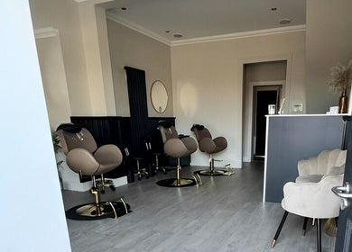 Chic salon interior at By Ellie Rose, Brightons, Scotland, GB featuring plush seating and modern decor.