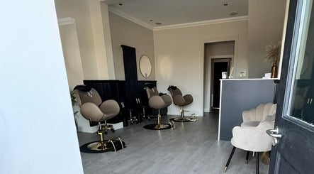 Chic salon interior at By Ellie Rose, Brightons, Scotland, GB featuring plush seating and modern decor.