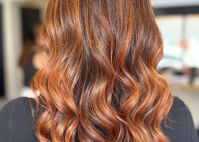 Luscious auburn waves styled at Hairology Rushden in Rushden, England, GB. Perfect for a glamorous hair makeover.