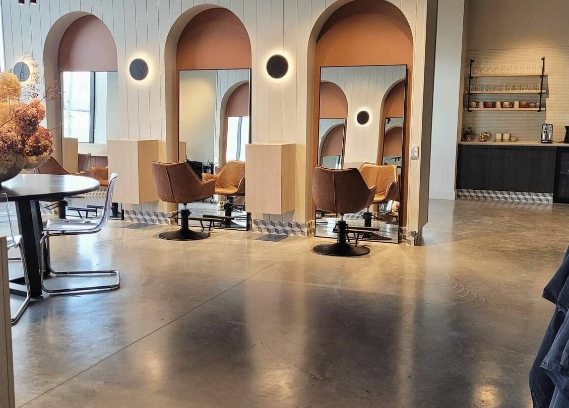 Modern salon interior at Unique Artist, Gledswood Hills, New South Wales, AU with stylish chairs and mirrors.