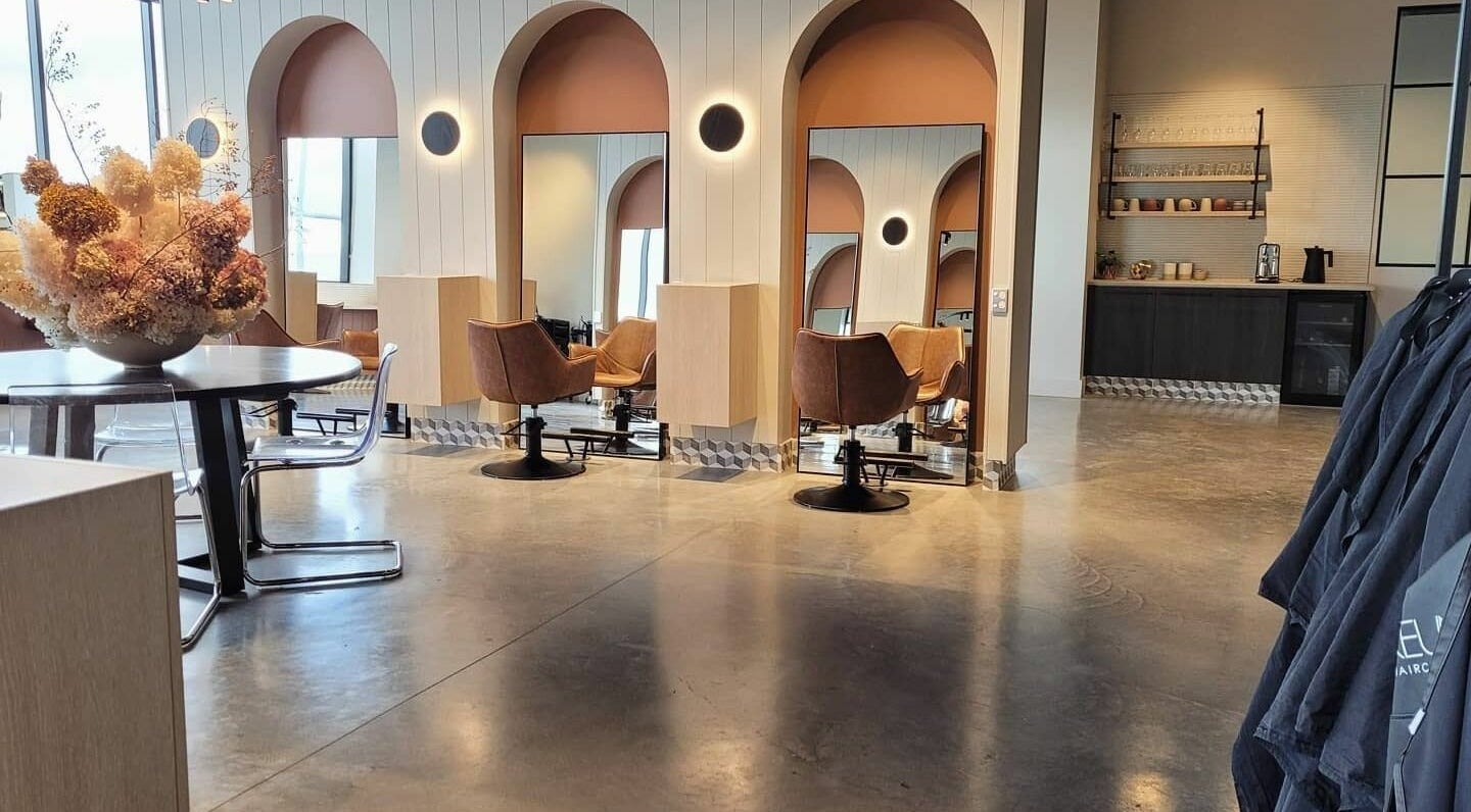 Modern salon interior at Unique Artist, Gledswood Hills, New South Wales, AU with stylish chairs and mirrors.