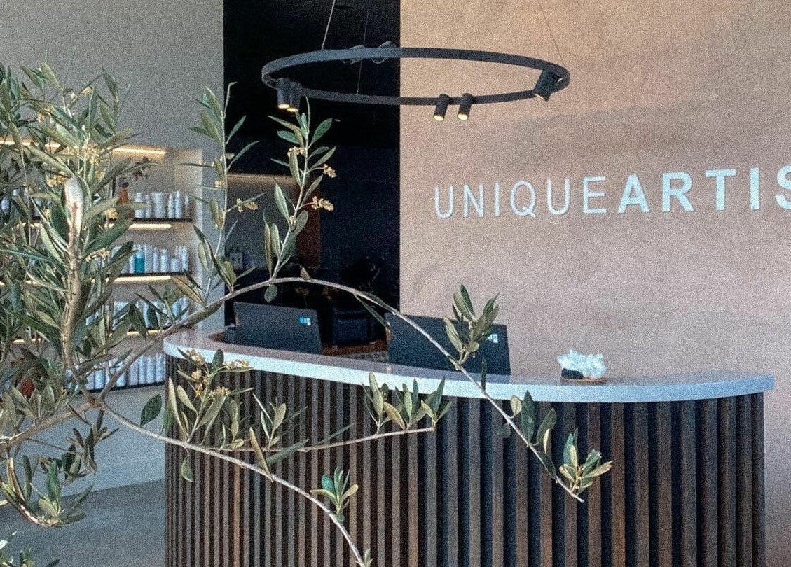 Elegant reception at Unique Artist, Gledswood Hills, NSW, AU with modern decor and lush greenery.