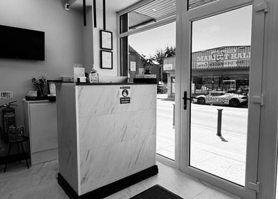 Bright reception area of The Dermagen Clinic Bolton, featuring reception desk and large windows in Bolton, England, GB.