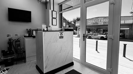 Bright reception area of The Dermagen Clinic Bolton, featuring reception desk and large windows in Bolton, England, GB.