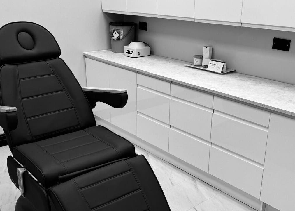 Relaxing treatment room at The Dermagen Clinic Weybridge, Weybridge, England, GB with a sleek black chair.