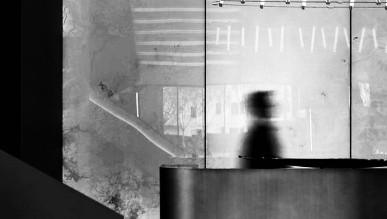 Sleek interior design at MCR in Bolton, England, GB with artistic reflections on glass walls.