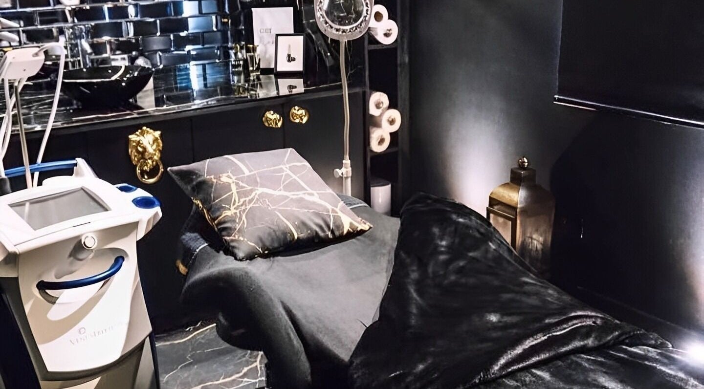 Elegant treatment room at Noir Tanning & Beauty, Great Dunmow, England, GB, featuring plush decor and modern equipment.