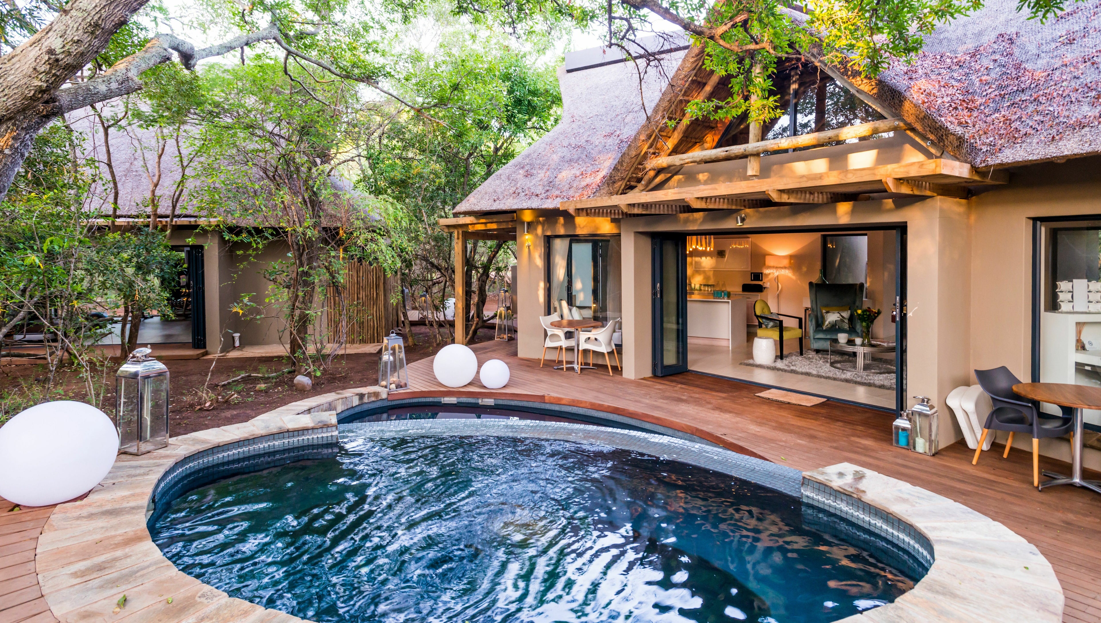 Relaxing outdoor pool area at AM Spa Hoedspruit in Hoedspruit, Limpopo, ZA surrounded by lush greenery.