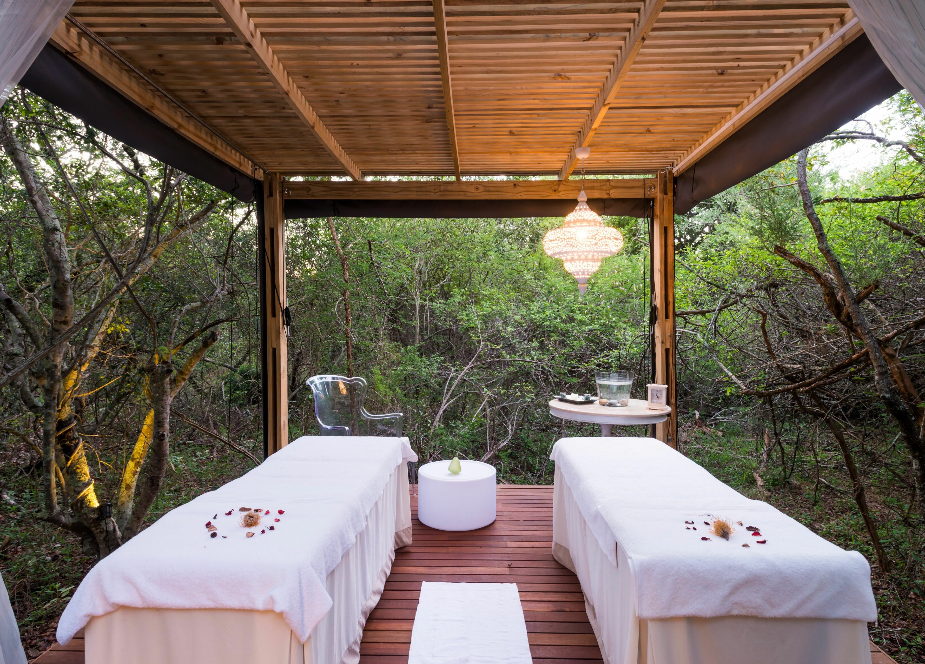 Relaxing outdoor massage setup at AM Spa Hoedspruit, Hoedspruit, Limpopo, ZA amidst lush greenery.