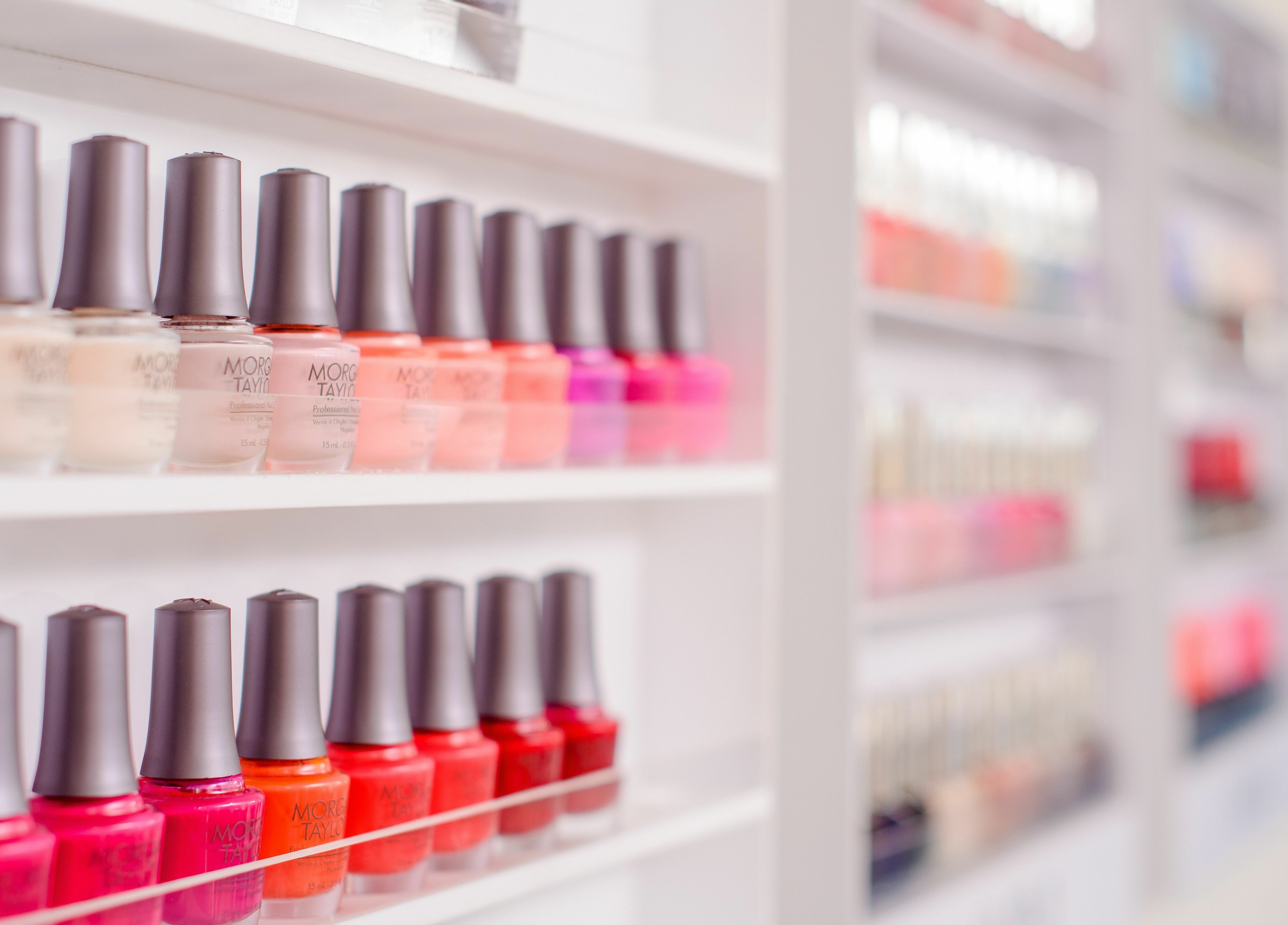 Vibrant nail polish display at AM Spa Kruger, Skukuza, Mpumalanga, ZA, showcasing diverse color options.