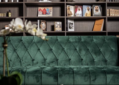 Luxurious green sofa at Ak Barbershop (Mina Alarab), Al Jazirah Al Hamra, Ras al Khaimah, AE. Modern and stylish decor.