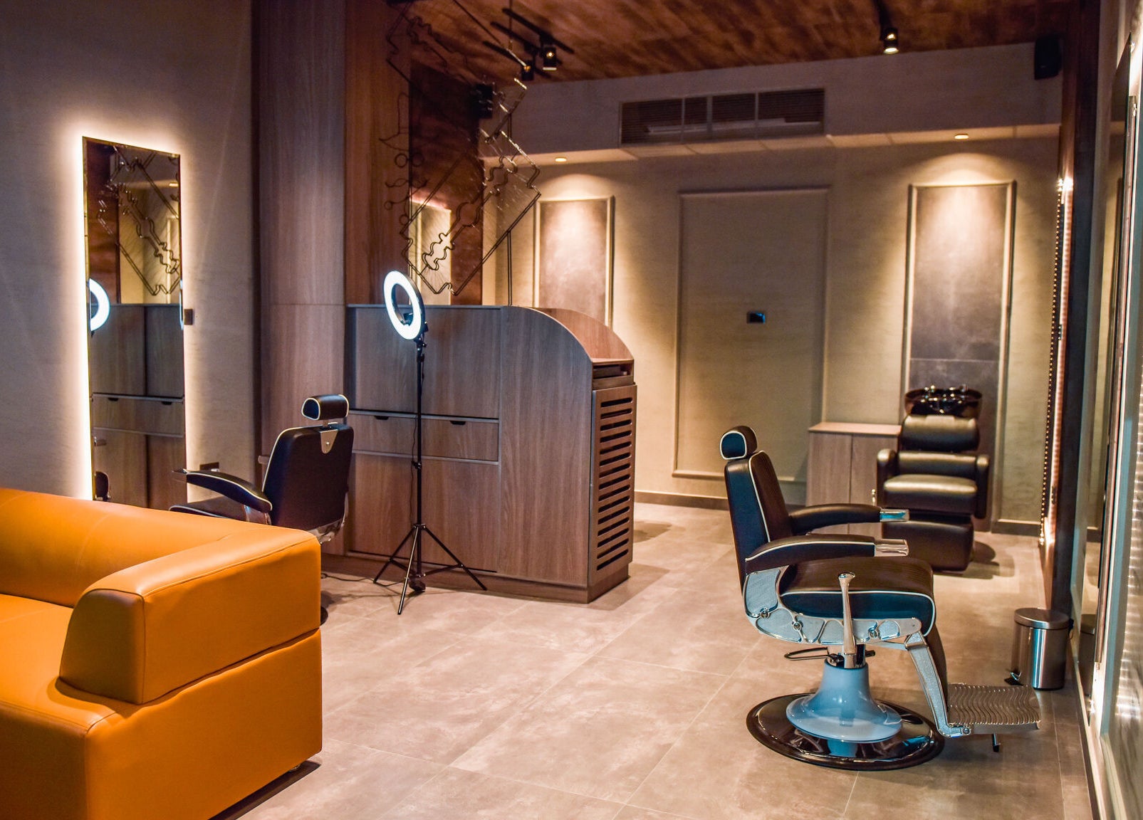 Chic salon interior at Fade, Muscat, bosher, OM with modern chairs and lighting.