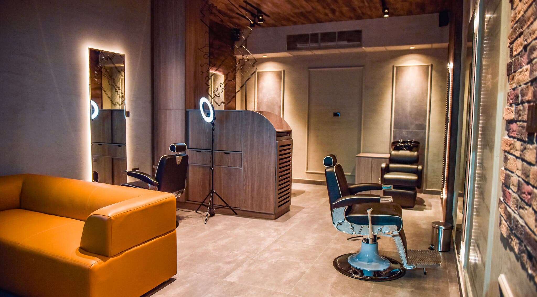 Chic salon interior at Fade, Muscat, bosher, OM with modern chairs and lighting.