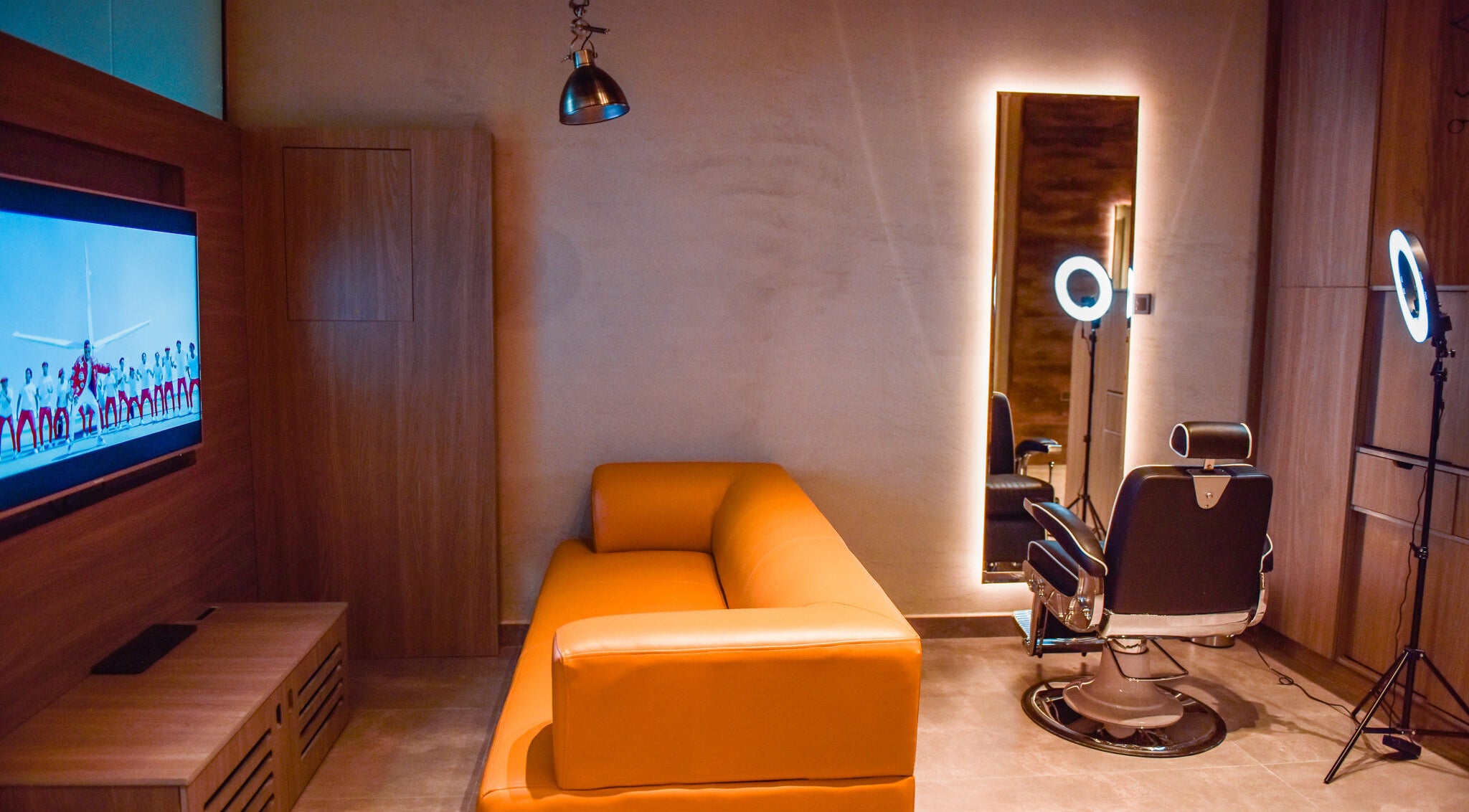 Sophisticated interior of Fade in Muscat, Bosher, OM with a modern sofa, TV, and styling chair.