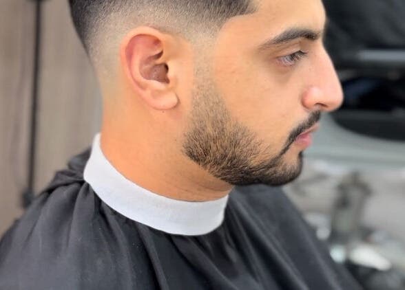 Close-up of a neat fade haircut at Fade, Muscat, bosher, OM showcasing precision styling.