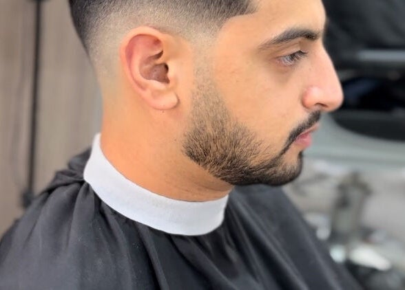 Close-up of a neat fade haircut at Fade, Muscat, bosher, OM showcasing precision styling.