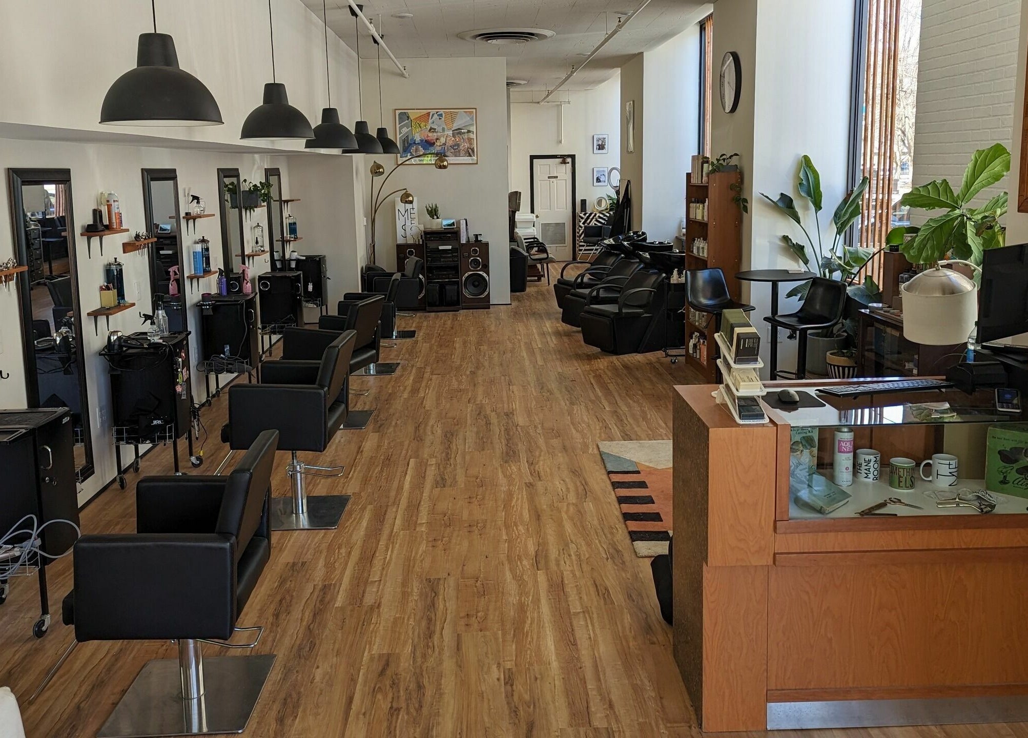 Interior of The Mane Room salon, Scranton, Pennsylvania, US, featuring chic styling chairs and modern decor.