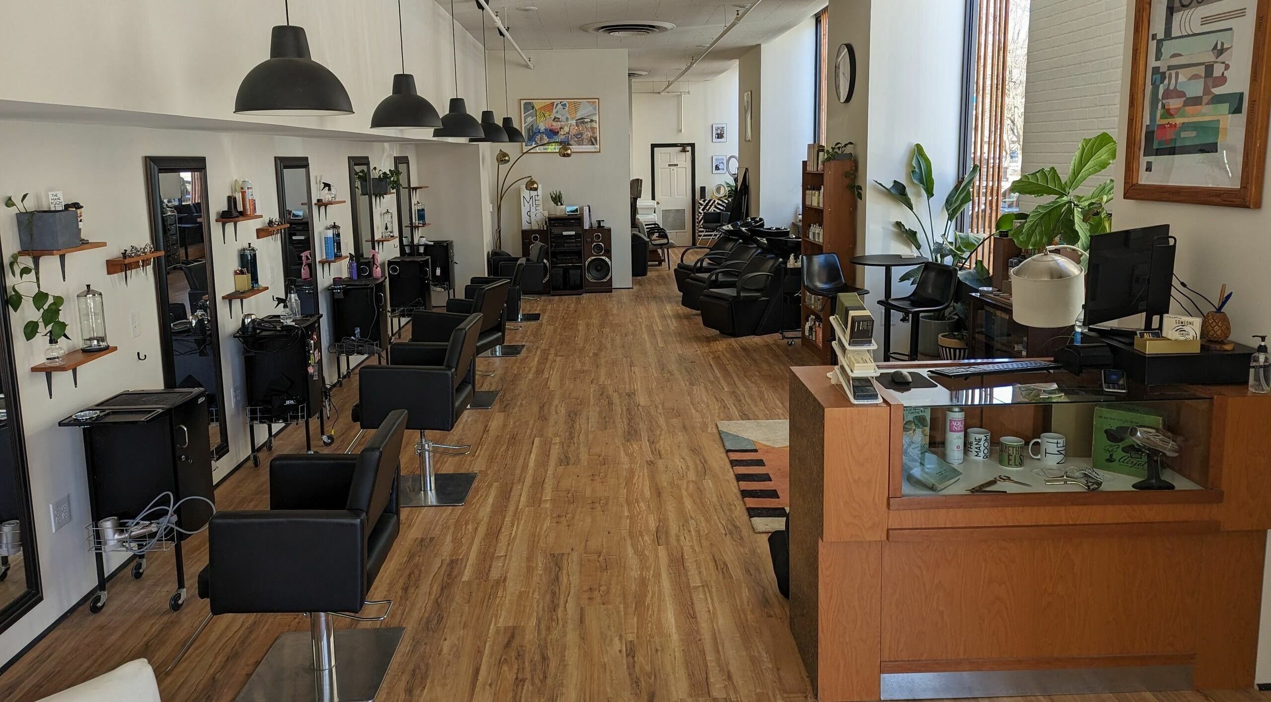 Interior of The Mane Room salon, Scranton, Pennsylvania, US, featuring chic styling chairs and modern decor.