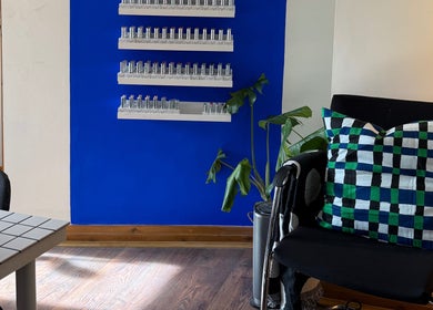 Elegant waiting area in The Painted Parlour, Holmfirth, England, GB with colorful decor and lush plant.