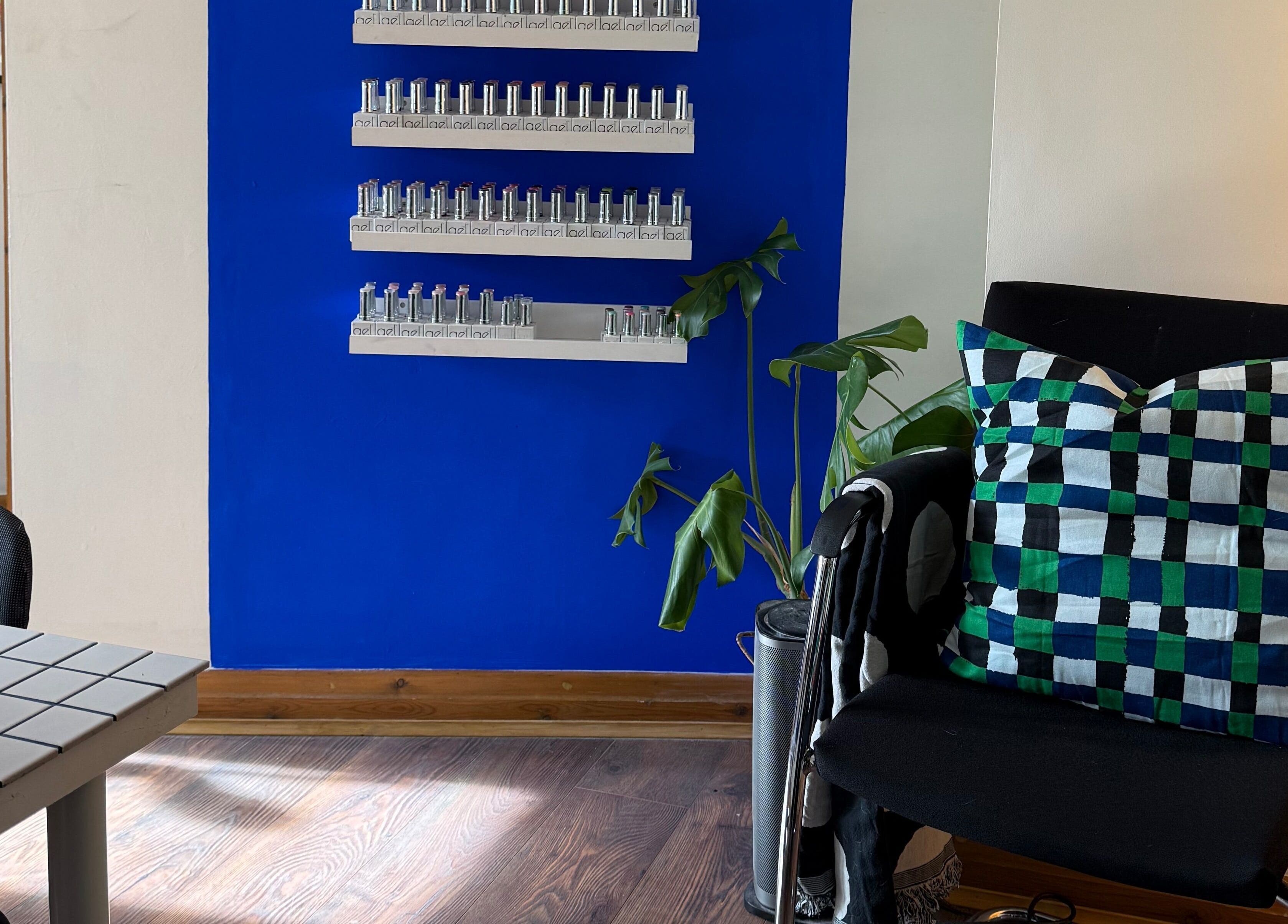 Elegant waiting area in The Painted Parlour, Holmfirth, England, GB with colorful decor and lush plant.
