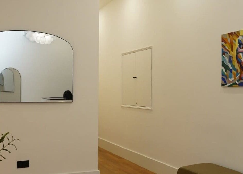 Modern interior at Manicured London, London, England, GB featuring mirror and abstract art.