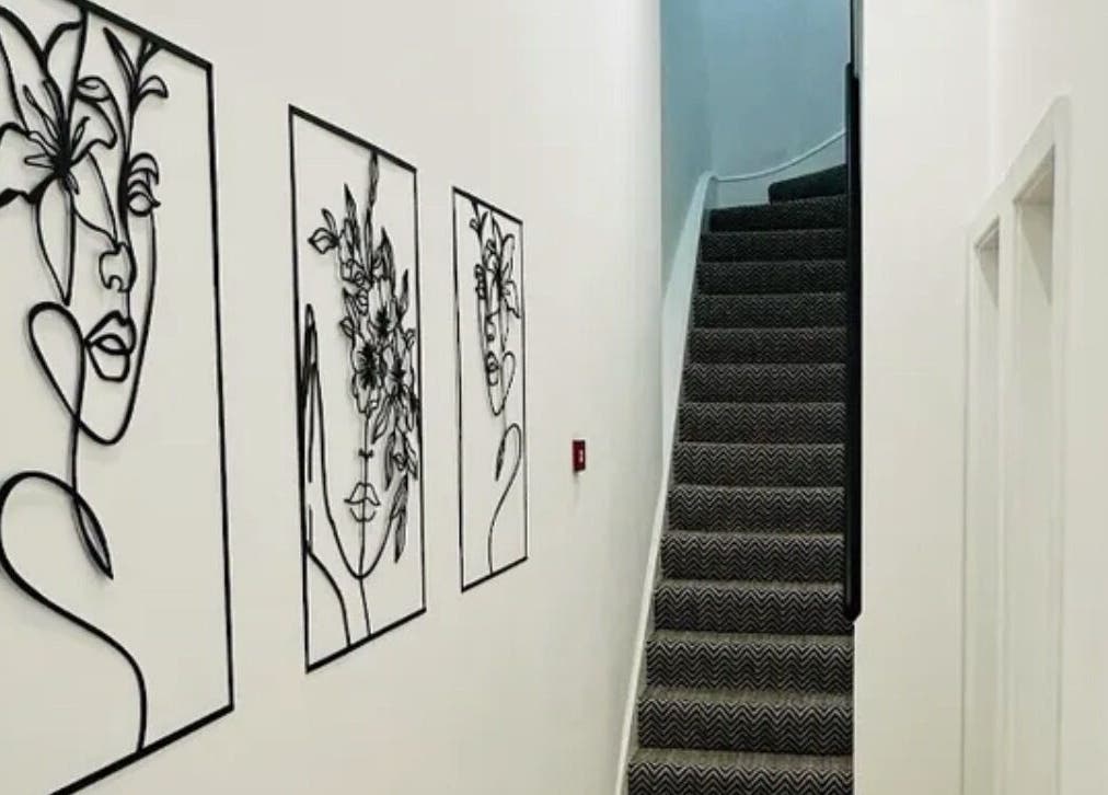 Elegant wall art and staircase at Manicured London, London, England, GB, creating a chic ambiance.