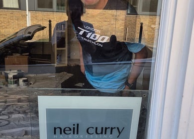 Reflection on Neil Curry Hairdressing Ltd window, Cambridge, England, GB.