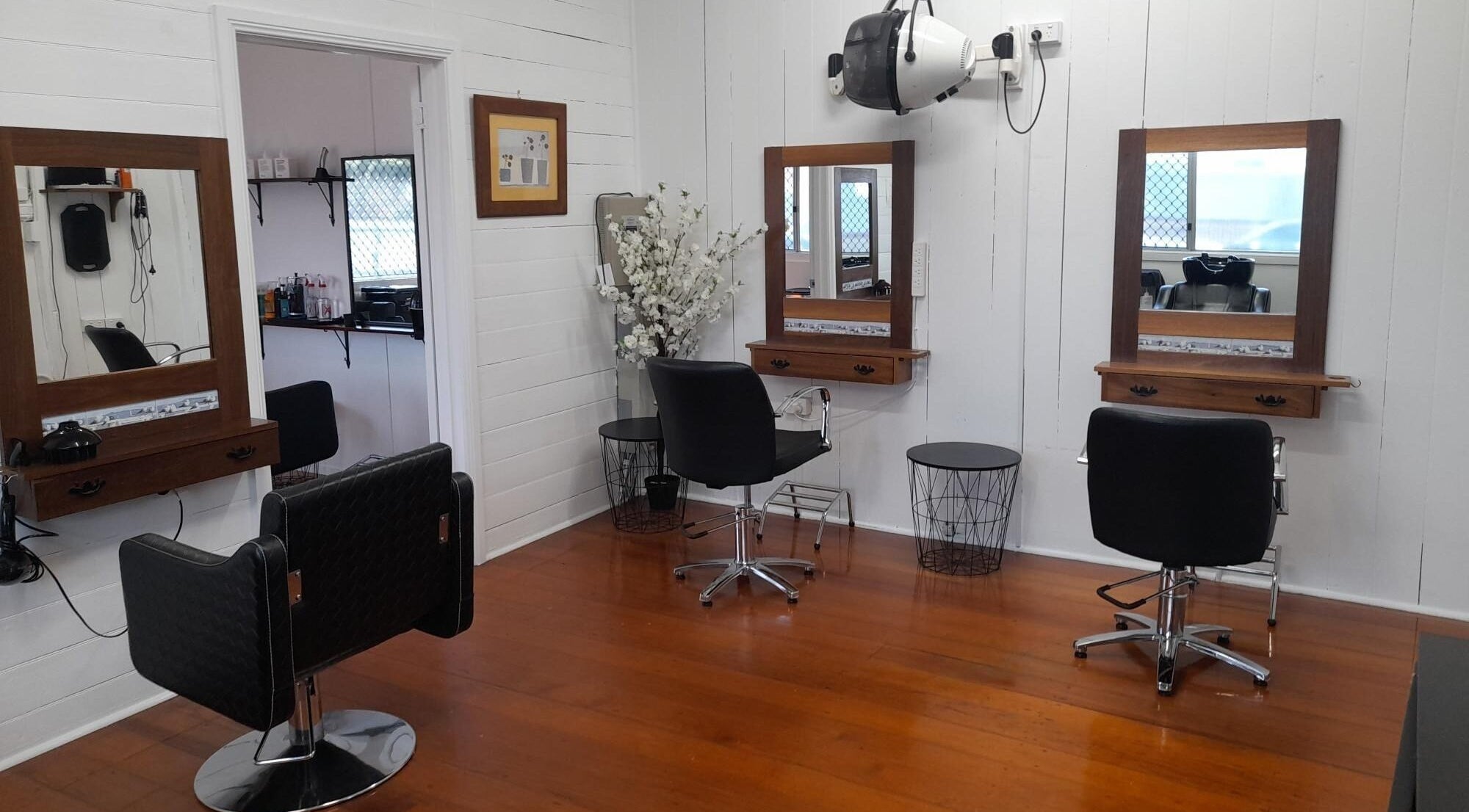 Elegant hair salon setup at Sadie's Hair Shed, Beaudesert, Queensland, AU with stylish chairs and mirrors.