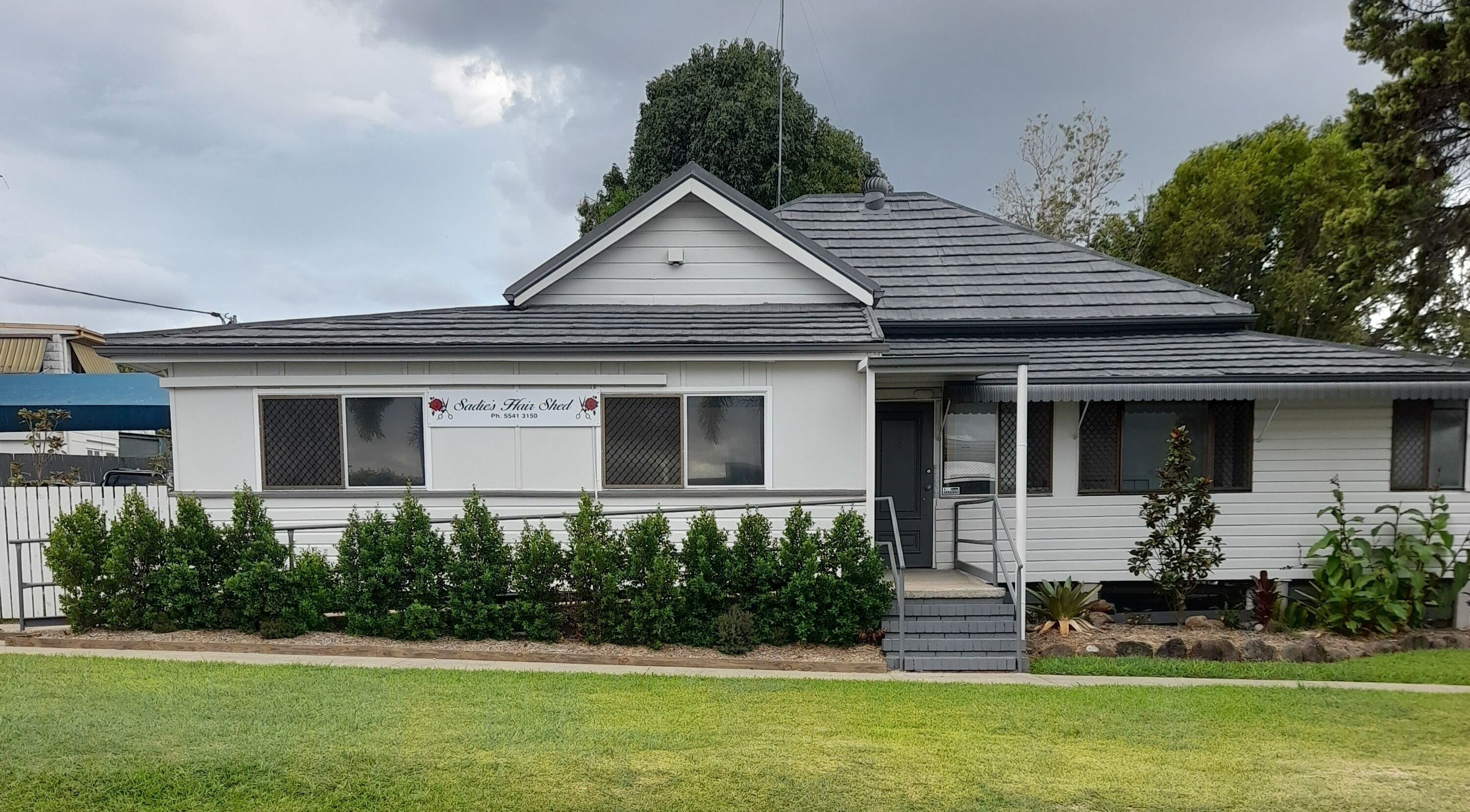 Front view of Sadie's Hair Shed, a quaint white building in Beaudesert, Queensland, AU.