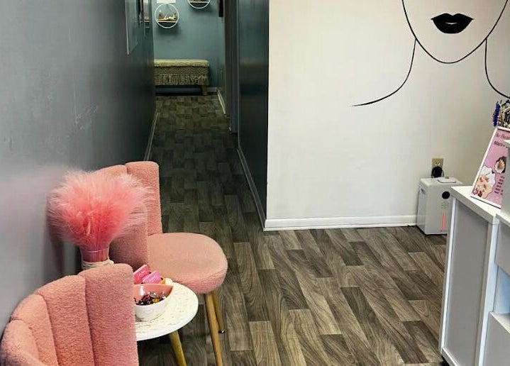 Stylish lobby at Bio Beauty Skincare and Wax Center, Gainesville, Florida, US, with pink chairs and decor.