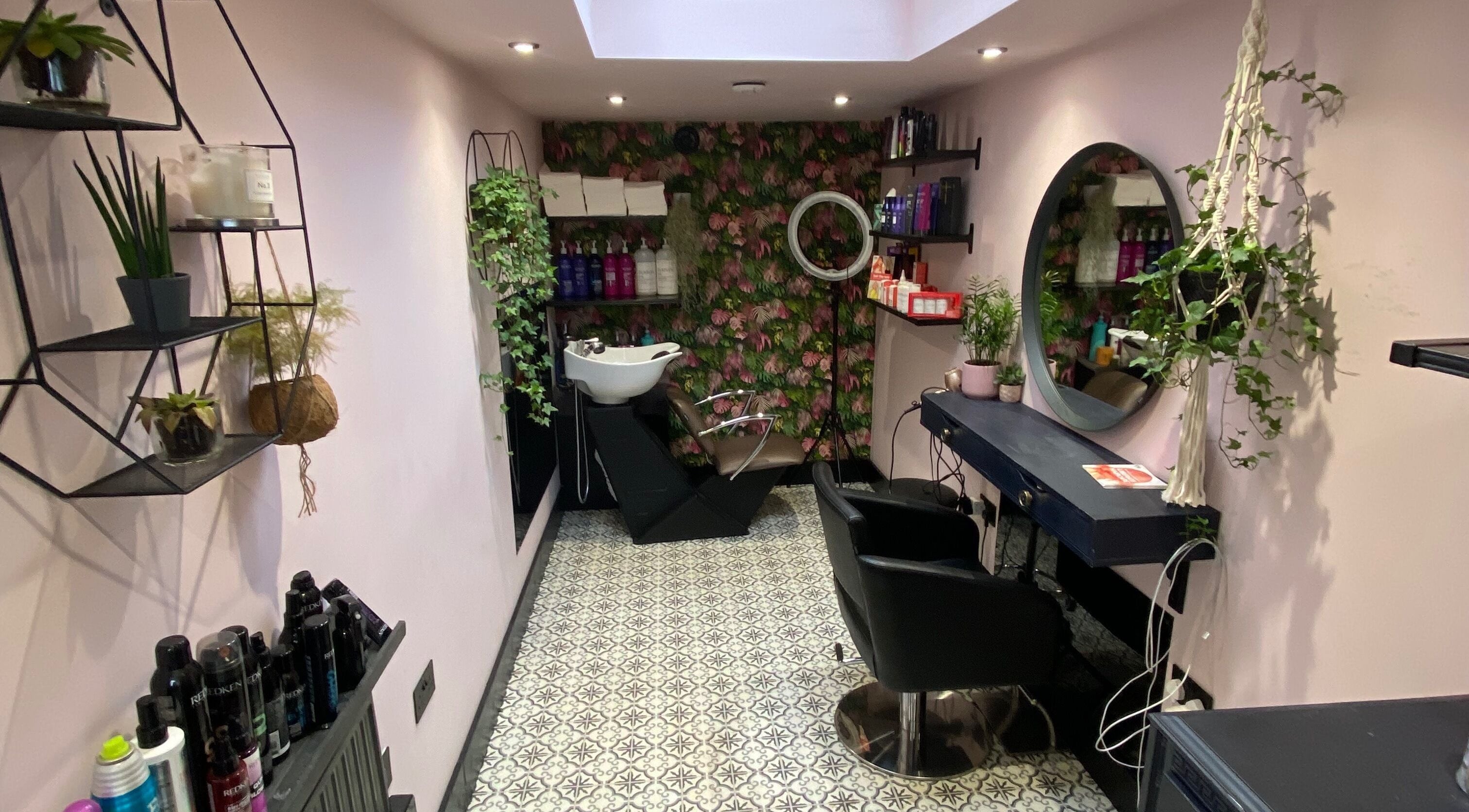 Elegant interior of Hair by Kelly in Bournemouth, GB, featuring stylish decor and modern hairdressing chairs.