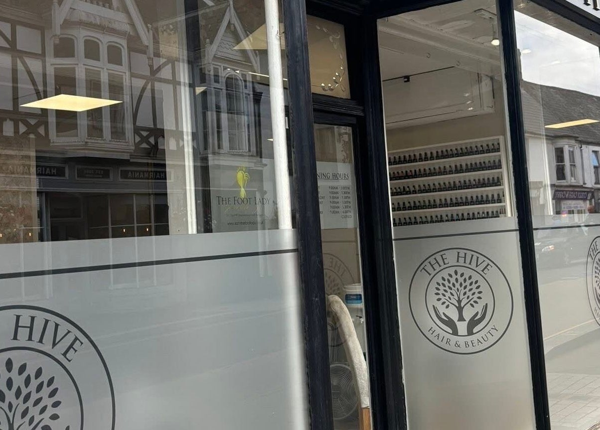 Front entrance of The Hive Beauty, Holistics & Hair, Cullompton, England, GB, showcasing elegant decor.